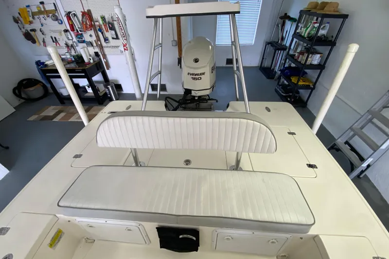 Slide: The Image of 2008 Famous Craft 18 boat with Evinrude 150 engine in a garage setting. - 50