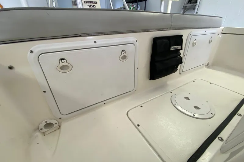 Slide: The Image of Interior of 2008 Famous Craft 18 boat with storage compartments and seating. - 52