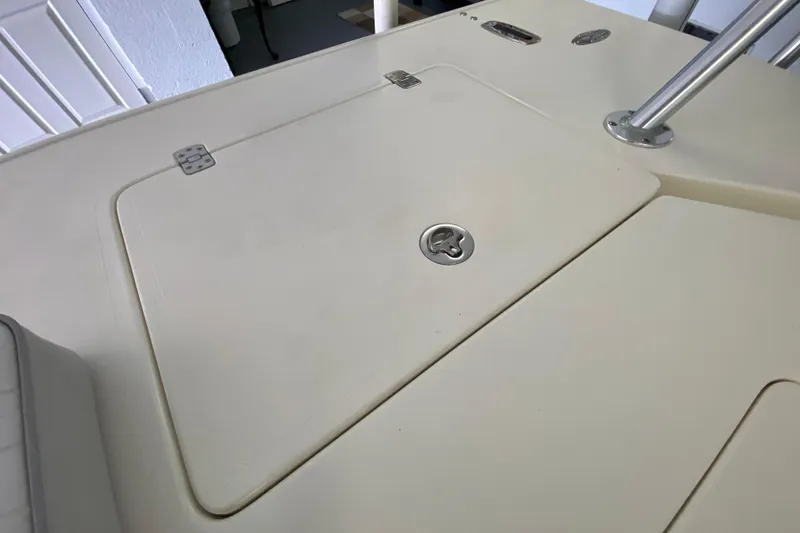 Slide: The Image of Hatch cover on 2008 Famous Craft 18 boat deck, featuring stainless steel hardware. - 55