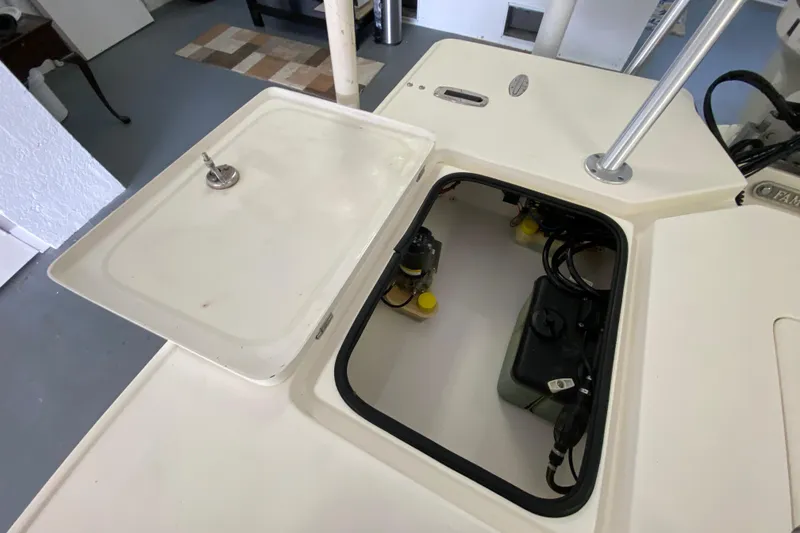 Slide: The Image of Open hatch of a 2008 Famous Craft 18 boat, revealing internal components. - 56