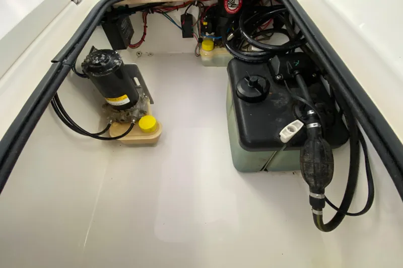 Slide: The Image of Engine compartment of 2008 Famous Craft 18 boat, showing fuel and electrical components. - 57