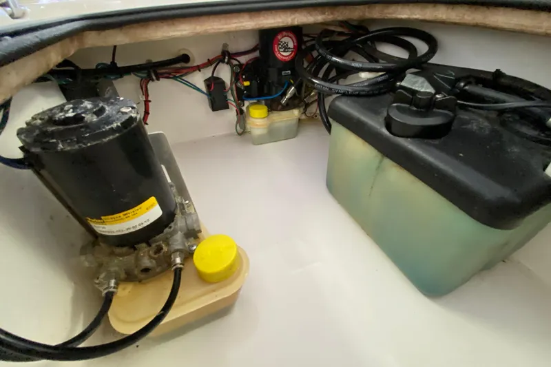 Slide: The Image of Boat engine compartment of 2008 Famous Craft 18, showing motor and fluid reservoirs. - 58