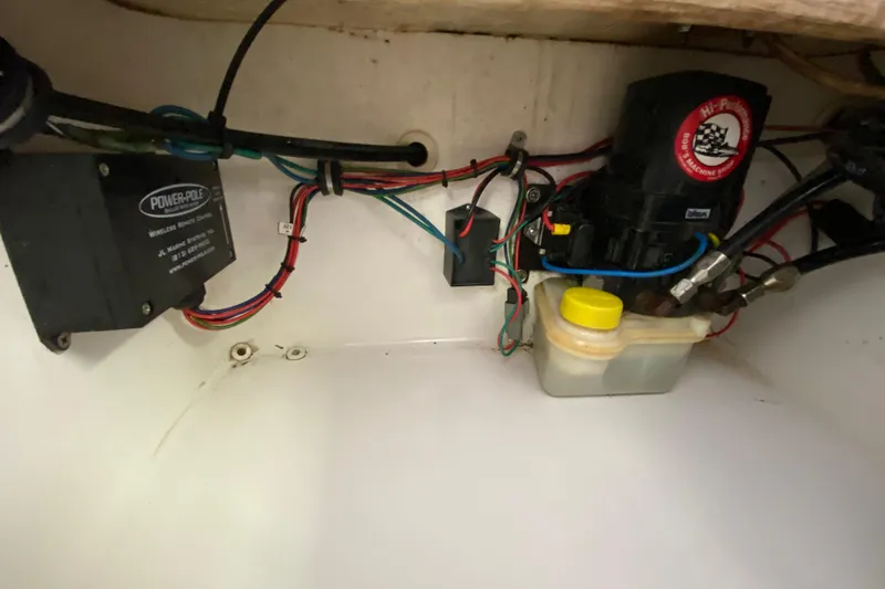 Slide: The Image of Electrical components and wiring inside a 2008 Famous Craft 18 boat. - 59