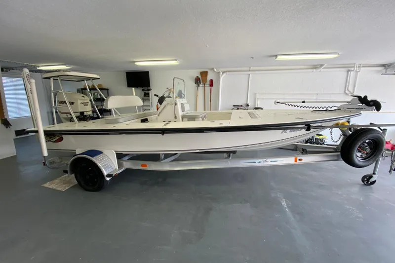 Slide: The Image of 2008 Famous Craft 18 boat on trailer in a garage setting. - 6