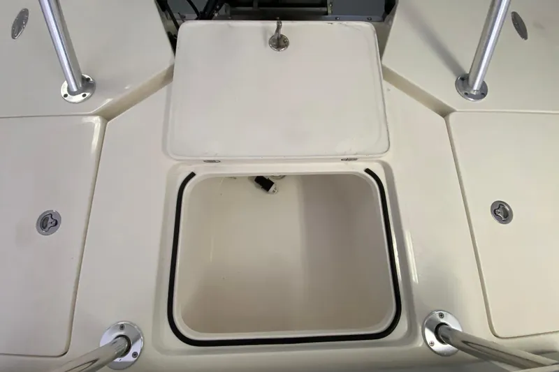 Slide: The Image of Open storage compartment on a 2008 Famous Craft 18 boat deck. - 61