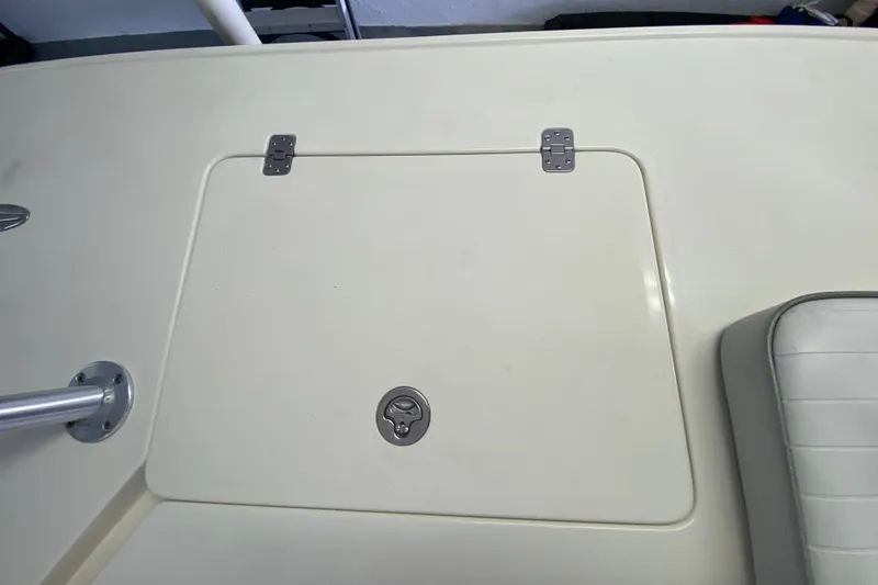 Slide: The Image of Hatch on 2008 Famous Craft 18 boat deck with metal hinges and latch. - 62