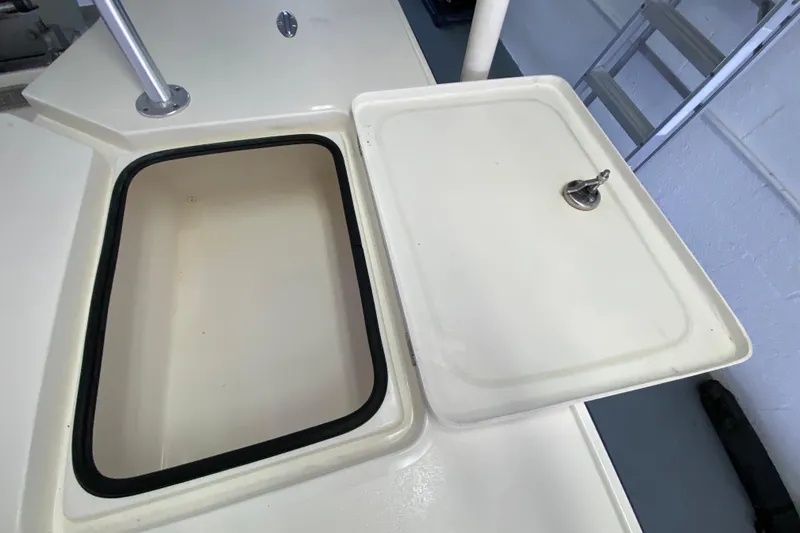 Slide: The Image of Open storage compartment on a 2008 Famous Craft 18 boat deck. - 63