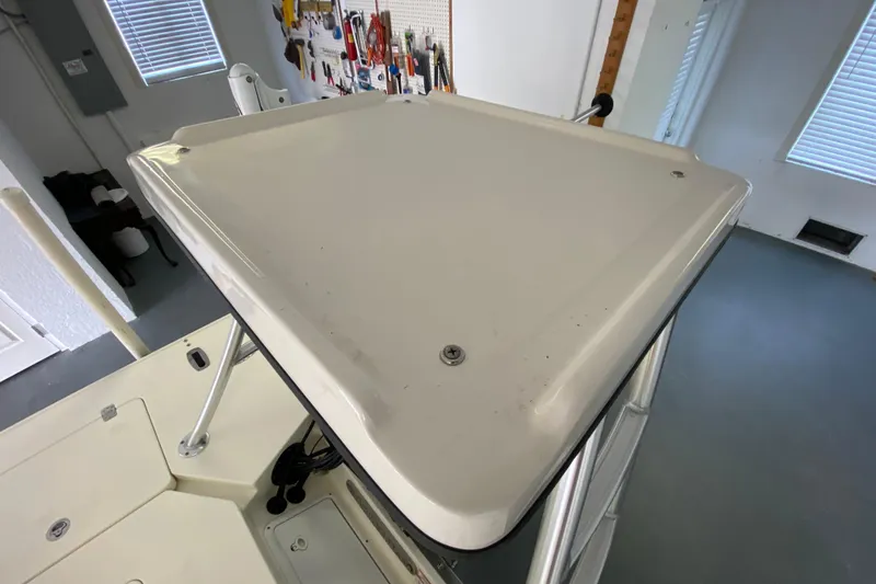 Slide: The Image of 2008 Famous Craft 18 boat top view in a garage setting. - 65