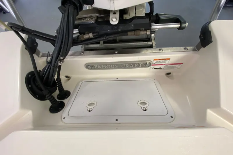 Slide: The Image of Rear view of a 2008 Famous Craft 18 boat with engine components visible. - 66