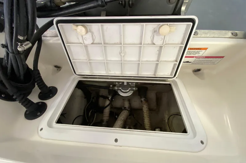 Slide: The Image of Open hatch of a 2008 Famous Craft 18 boat showing internal components. - 68