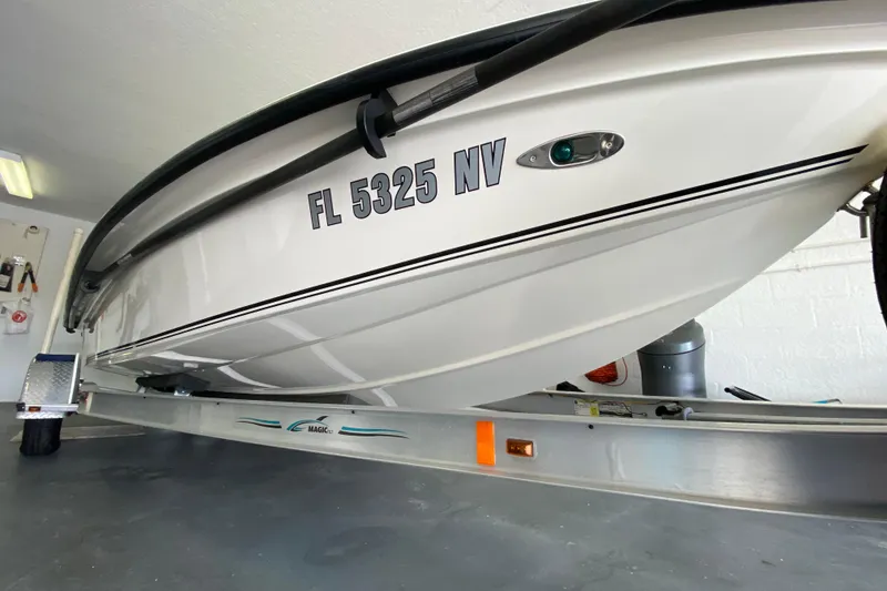 Slide: The Image of 2008 Famous Craft 18 boat on trailer in garage, registration FL 5325 NV. - 7