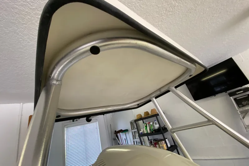 Slide: The Image of Aluminum frame of 2008 Famous Craft 18 boat in a garage setting. - 70