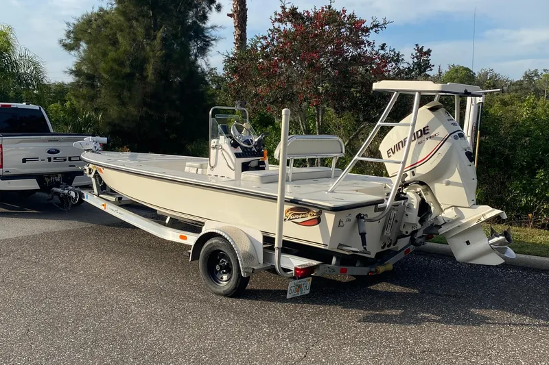 Slide: The Image of 2008 Famous Craft 18 boat on trailer, hitched to Ford F-150, parked on asphalt road. - 73