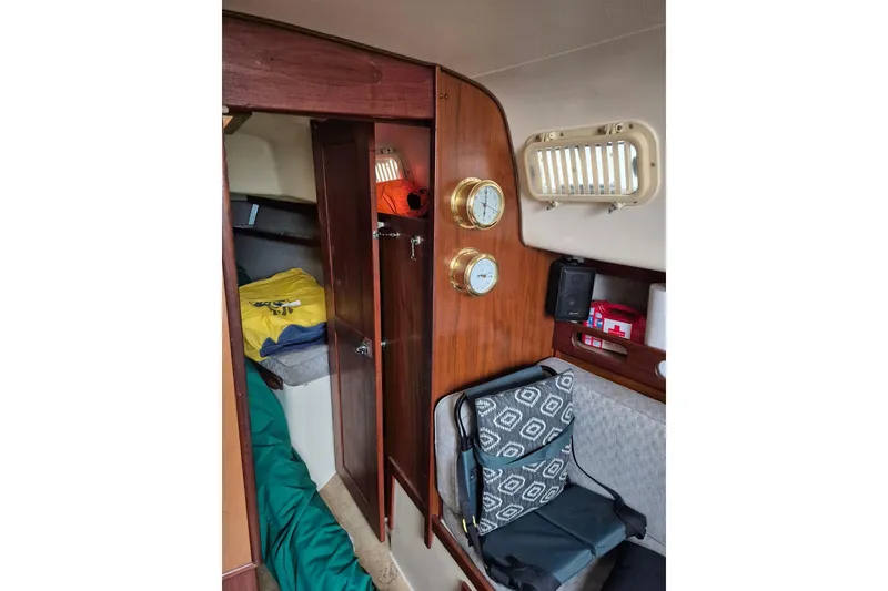 Slide: The Image of Interior of a 1978 Hunter 30 sailboat with wood paneling and nautical instruments. - 11