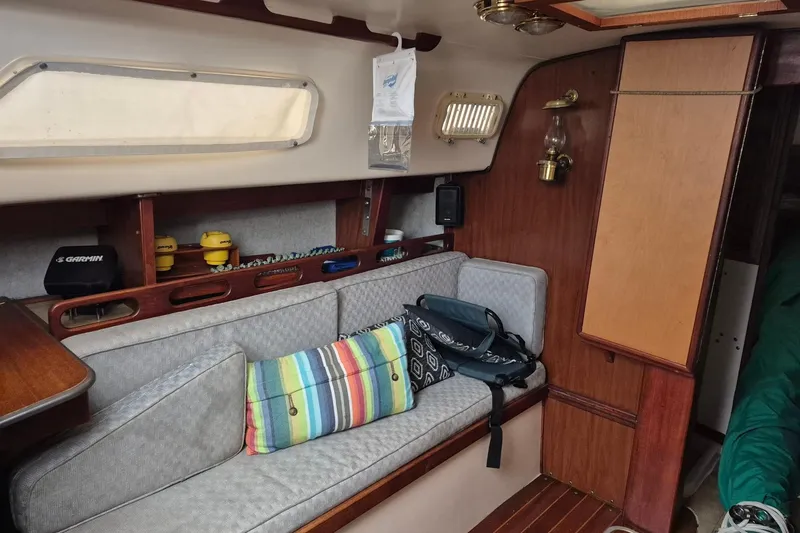 Slide: The Image of Interior of a 1978 Hunter 30 sailboat with cozy seating and nautical decor. - 12