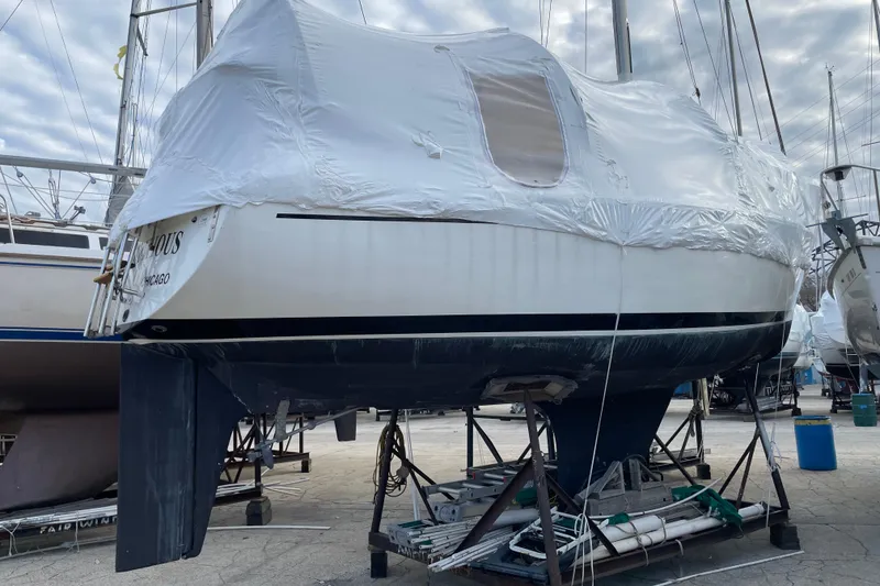 Slide: The Image of 1978 Hunter 30 sailboat covered in protective wrap, stored on a stand. - 14