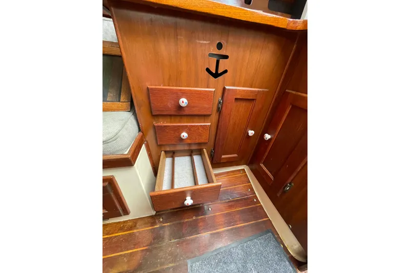 Slide: The Image of Interior of a 1978 Hunter 30 sailboat featuring wooden drawers and cabinets. - 20