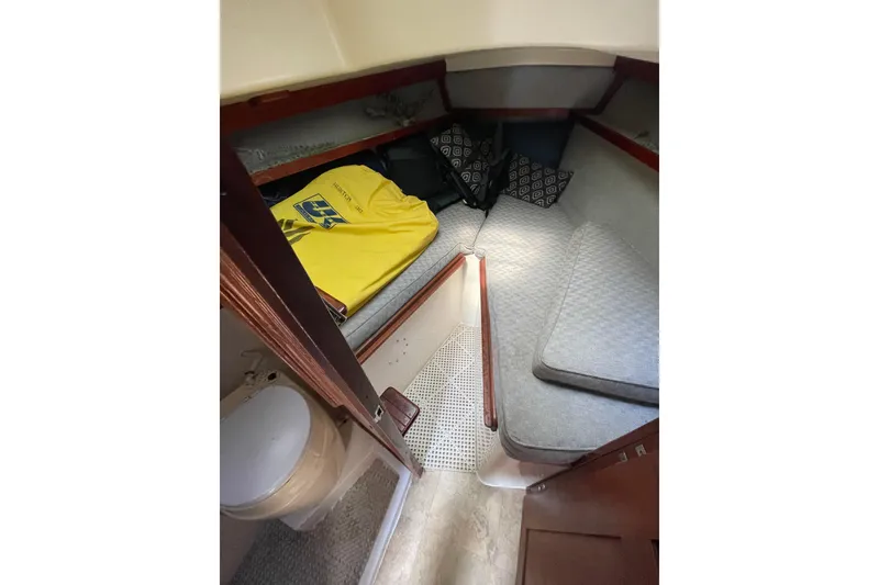 Slide: The Image of Cozy cabin interior of a 1978 Hunter 30 sailboat with cushions and a small toilet. - 24