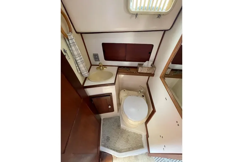 Slide: The Image of 1978 Hunter 30 yacht bathroom with sink, toilet, and mirror. - 26