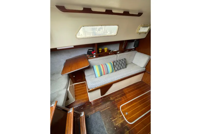 Slide: The Image of Interior of a 1978 Hunter 30 sailboat with cozy seating and colorful cushions. - 28
