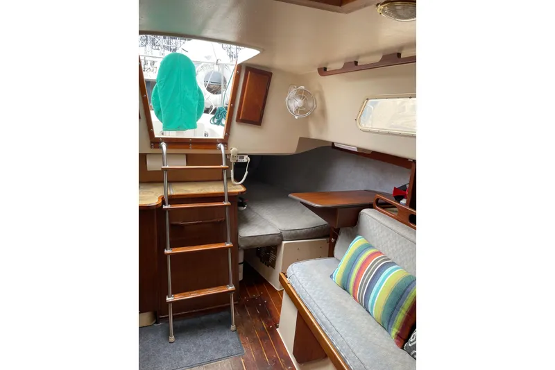 Slide: The Image of Interior of a 1978 Hunter 30 sailboat with cozy seating and wooden ladder. - 29
