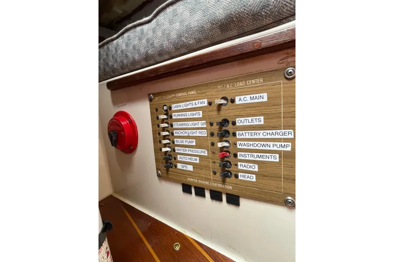 Slide: The Image of Electrical control panel on a 1978 Hunter 30 sailboat, featuring labeled switches and a red power knob. - 34