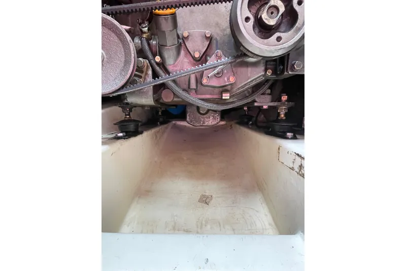 Slide: The Image of Engine compartment of a 1978 Hunter 30 sailboat, showing mechanical components and belts. - 37