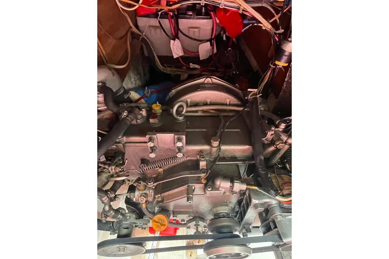 Slide: The Image of Engine of a 1978 Hunter 30 sailboat, showcasing mechanical components and wiring. - 38