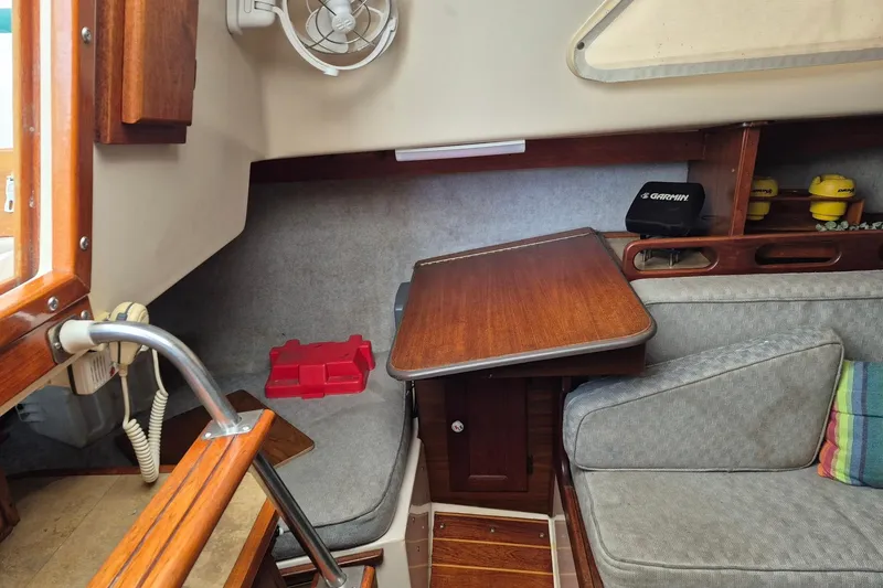 Slide: The Image of Interior of a 1978 Hunter 30 sailboat with wooden table and seating area. - 9