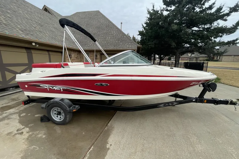 Slide: The Image of 2011 Sea Ray 175 Sport boat on trailer, parked in driveway. - 4