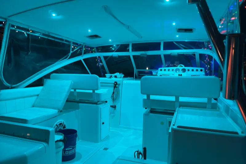 Slide: The Image of Interior of 2001 Cabo 35 Express boat with blue ambient lighting. - 15