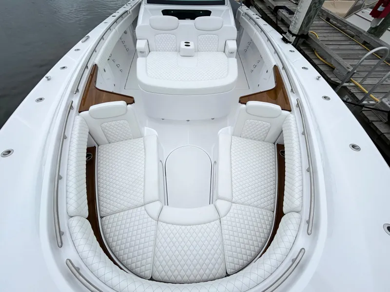 Slide: The Image of Luxurious 2025 HCB 48 Campeon boat with elegant white seating and wood accents. - 12