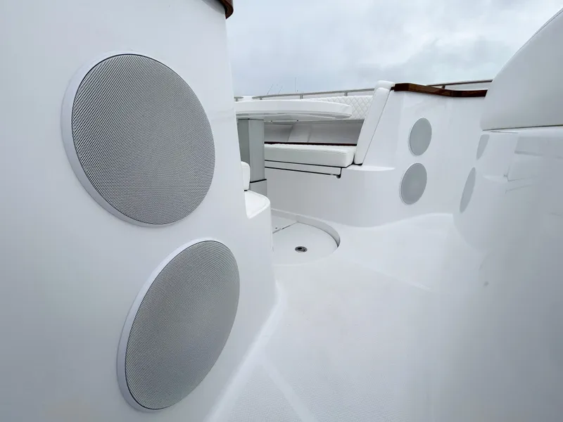 Slide: The Image of 2025 HCB 48 Campeon boat interior with sleek white seating and speaker system. - 20