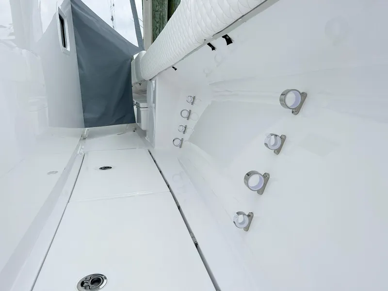 Slide: The Image of 2025 HCB 48 Campeon boat interior with rod holders and sleek white finish. - 21