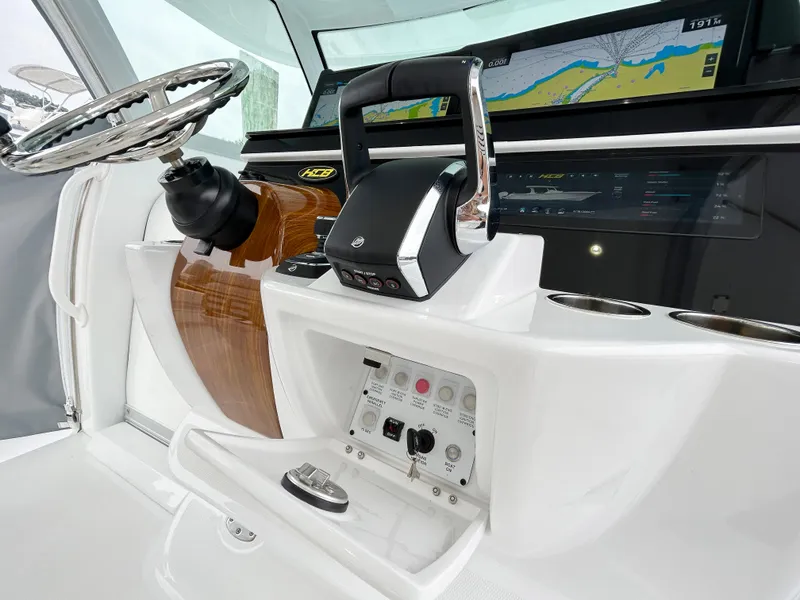 Slide: The Image of 2025 HCB 48 Campeon boat dashboard with steering wheel and navigation controls. - 25