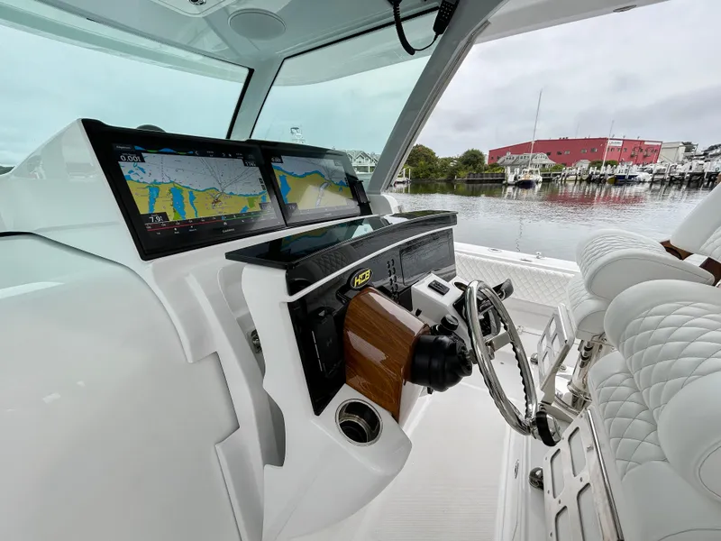 Slide: The Image of Helm of 2025 HCB 48 Campeon boat with navigation screens and luxurious seating. - 33