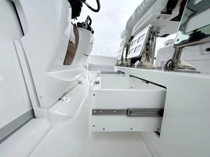 Slide: The Image of 2025 HCB 48 Campeon boat interior with open storage drawer. - 38