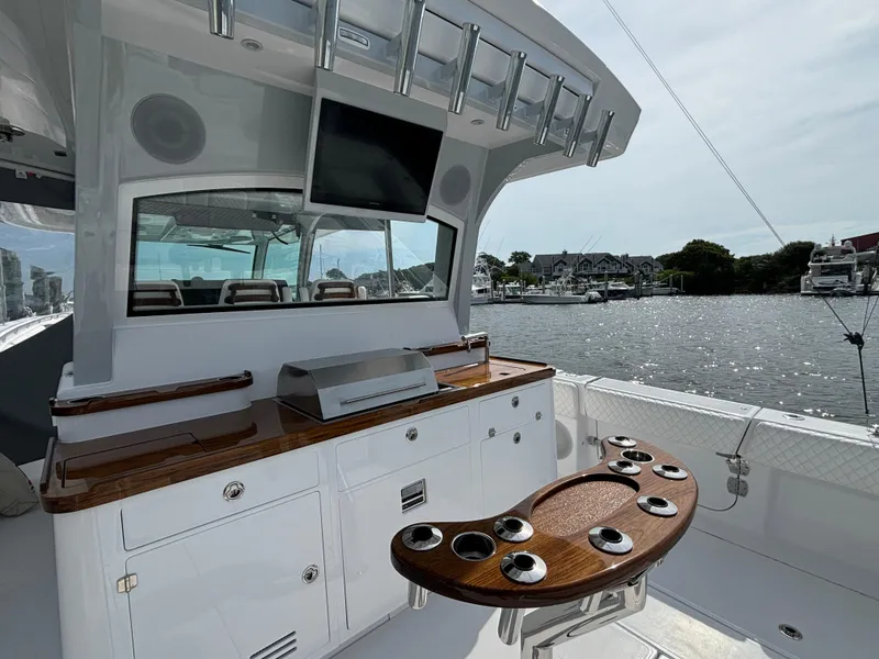 Slide: The Image of 2025 HCB 48 CAMPEON luxury yacht with outdoor kitchen and rod holders. - 49