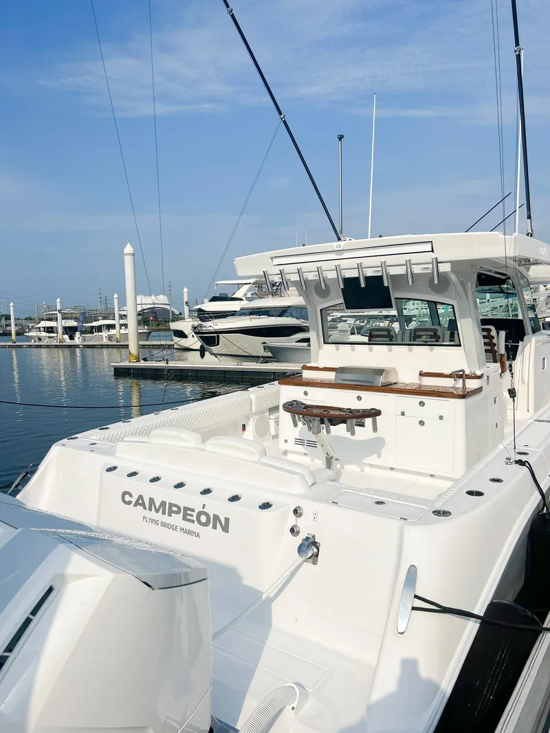 Slide: The Image of 2025 HCB 48 CAMPEON luxury boat docked at marina. - 79