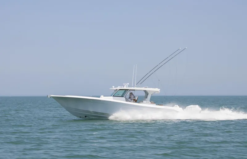 Slide: The Image of 2025 HCB 48 CAMPEON boat cruising on open water. - 8