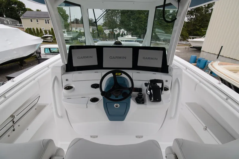 Slide: The Image of 2025 HCB 42 Lujo boat helm with Garmin displays and steering wheel. - 11