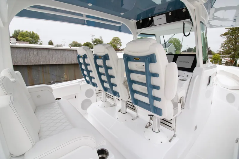 Slide: The Image of 2025 HCB 42 Lujo boat cockpit with Garmin navigation displays and steering wheel. - 12