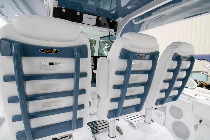 Slide: The Image of 2025 HCB 42 Lujo boat interior with luxurious white seating and modern design. - 17