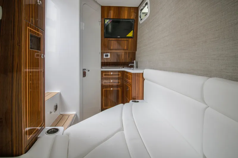 Slide: The Image of Luxurious interior of 2025 HCB 42 Lujo boat with white seating and wood accents. - 37