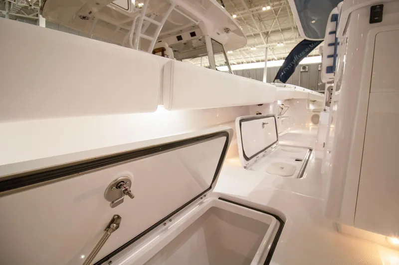 Slide: The Image of 2025 HCB 42 Lujo boat interior with open storage compartment, sleek white design. - 50