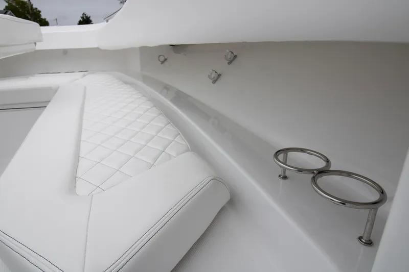 Slide: The Image of 2025 HCB 42 Lujo boat interior with white cushioned seating and storage compartments. - 6