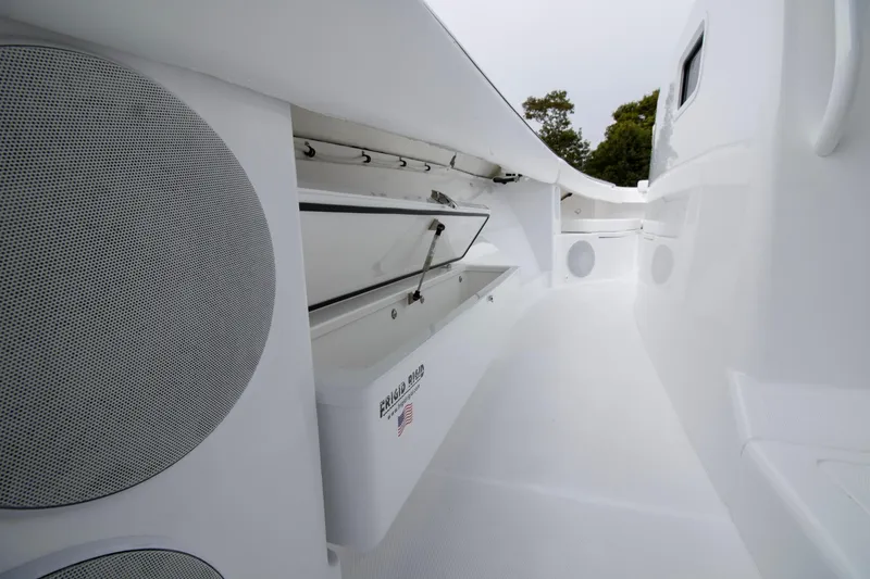 Slide: The Image of 2025 HCB 42 Lujo boat interior with white quilted seating and cup holders. - 7