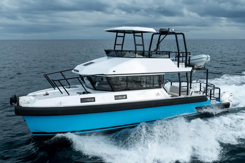 Slide: The Image of 2023 Vandal 46 Explorer yacht cruising on open sea under cloudy skies. - 1