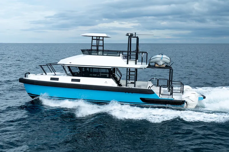 Slide: The Image of 2023 Vandal 46 Explorer cruising on open sea under cloudy skies. - 2