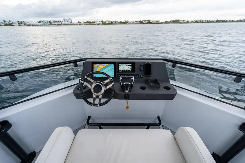 Slide: The Image of Cockpit of 2023 Vandal 46 Explorer boat with steering wheel and navigation screens. - 20